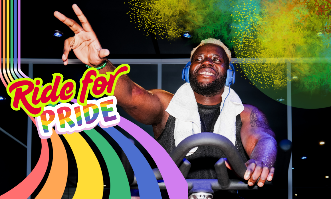 Image of man in indoor cycling studio with bright colours, celebrating the feel good vibes
